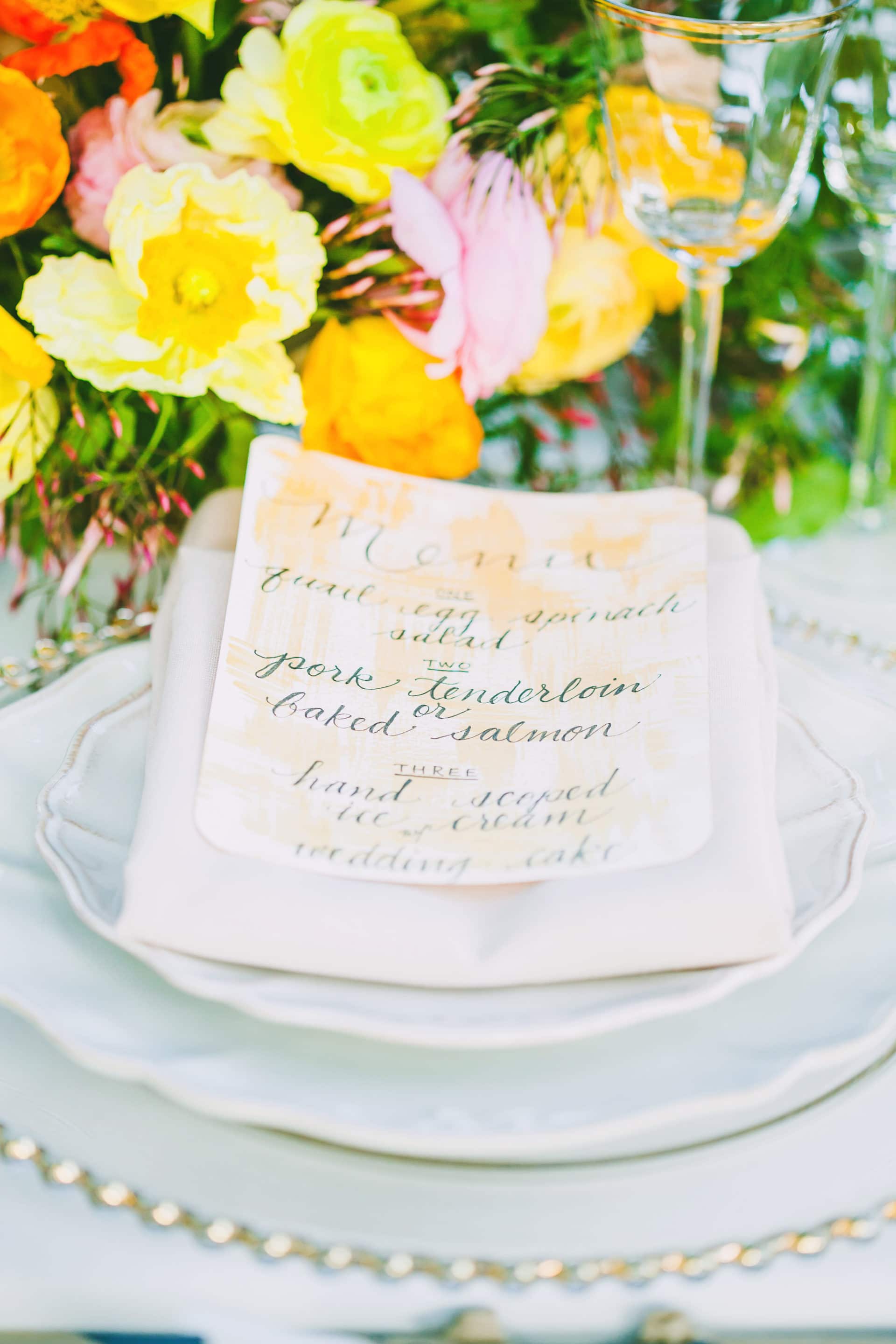 A beautiful table arrangement, bouquet, place setting and designed menu for a micro wedding.