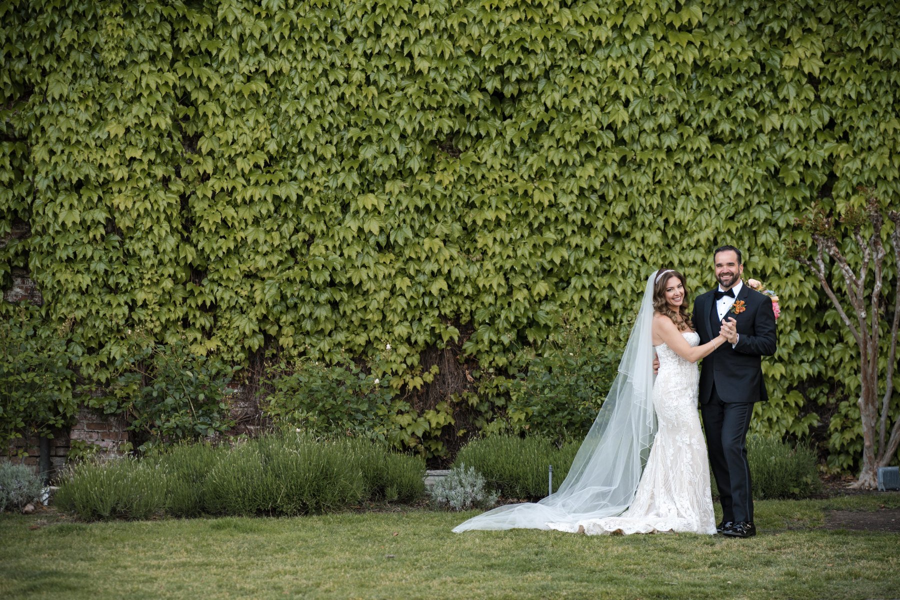 This Napa Valley wedding at the Estate Yountville Wedding venue show  a smiling bride and groom.  Wedding planned by Blissful Events. Photo by Lily Rose.